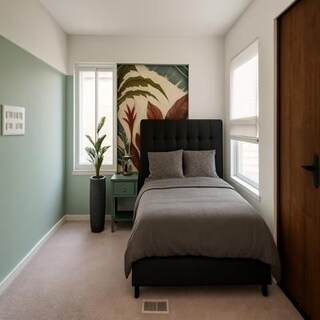 Bedroom with Green Accent Wall and Soft Furnishings