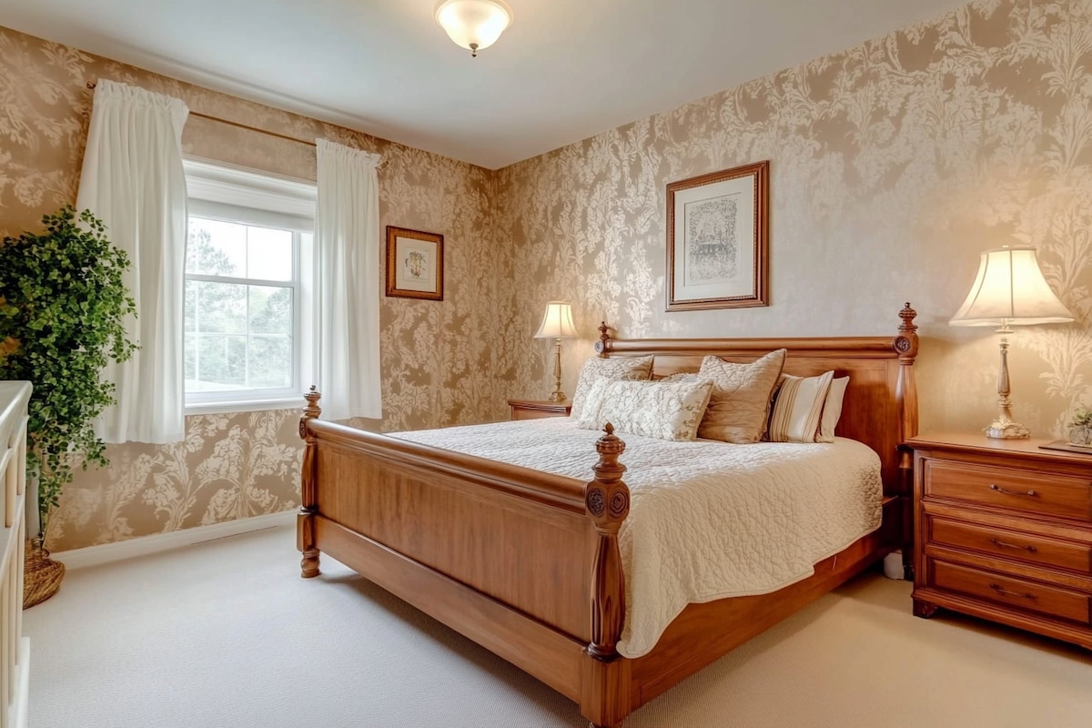 Traditional Master Bedroom Design With Beige Damask Wallpaper And Wooden Furniture