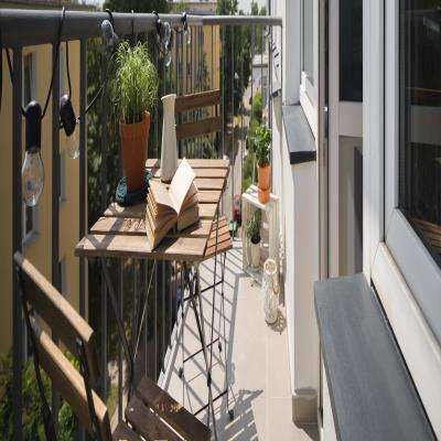 Simple Modern Balcony Design with a Wooden Table and Chairs