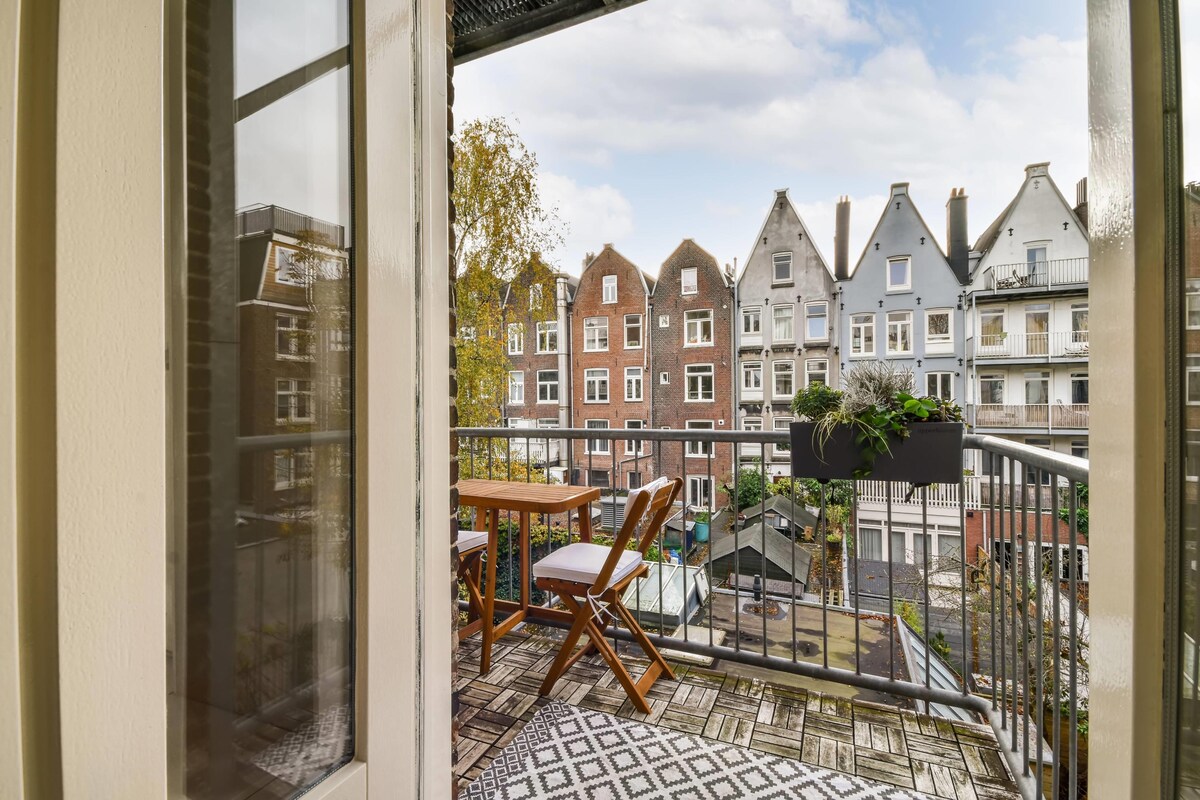 Elegant Modern Balcony Design with a Wooden Table and Chairs Elegant Modern Balcony Design with a Wooden Table and Chairs