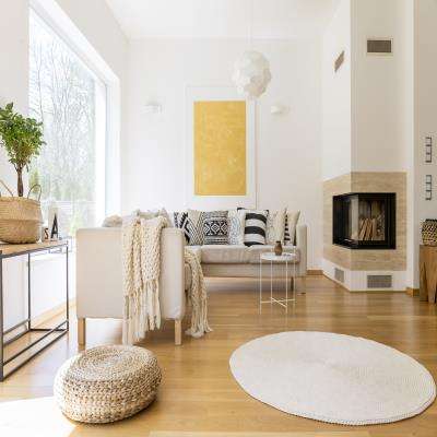 White Living Room Design With Sophisticated Details and A Corner Fire Place