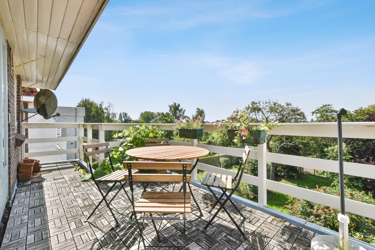 Elegant Contemporary Balcony Design with a Wooden Table and Chairs