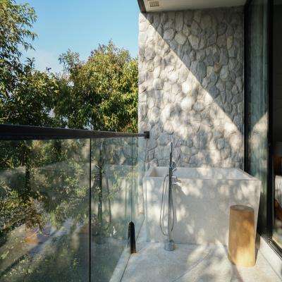 Elegant Modern Balcony Design with a Stone Wall