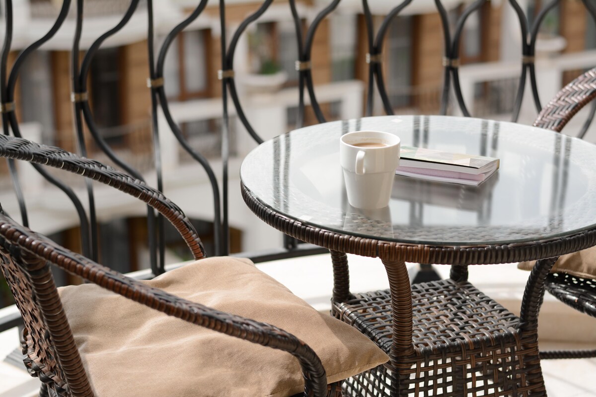 Cosy Modern Balcony Design with a Glass Coffee Table Cosy Modern Balcony Design with a Glass Coffee Table