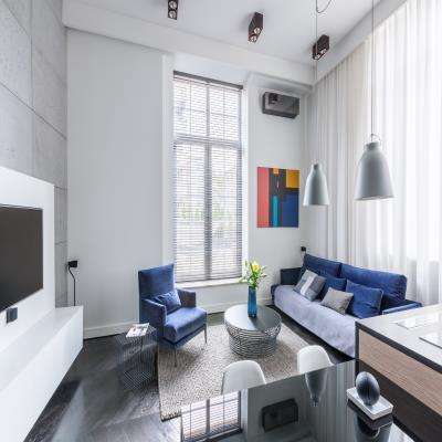 Clean Grey Walled Living Room Design Featuring Abstract Wall Art