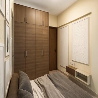 Bedroom with Wooden Wardrobe and Textured Wall Panels