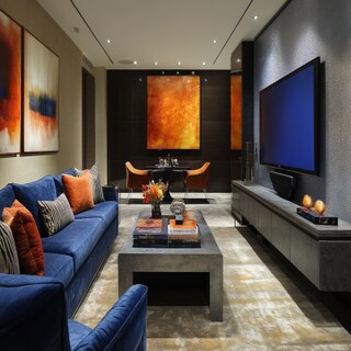 Contemporary Living Room Design With Blue Loveseat Sofa And A Grey Textured TV Console