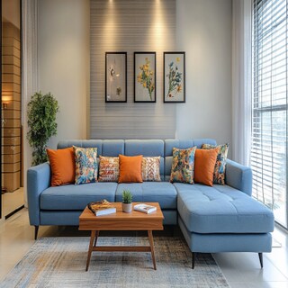 Modern Living Room Design With L-Shaped Blue Sofa And Printed Cushions