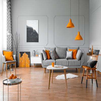Vibrant orange and Grey Living Room Design With Wooden Flooring And A Chandelier