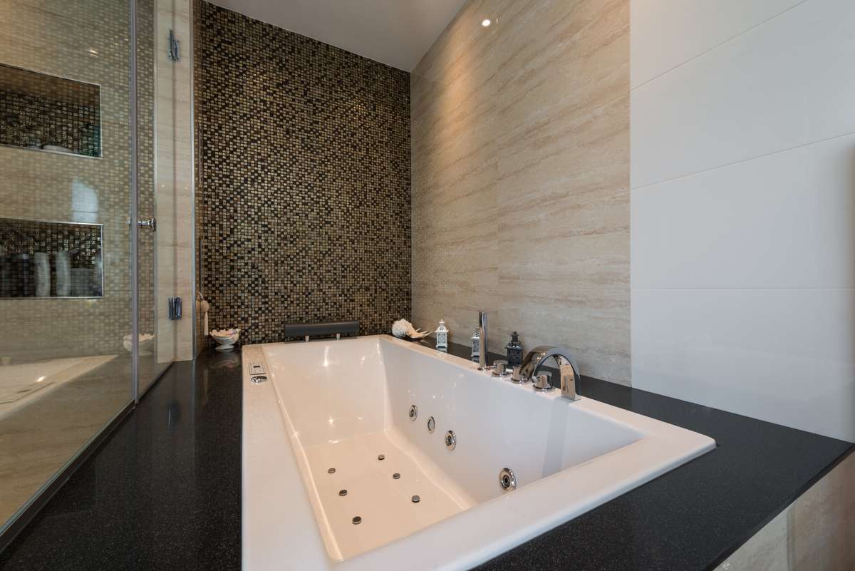 Luxurious Bathroom Design with Jacuzzi Tub and Marble Walls