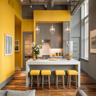 Calm Yellow and Grey Wall Colour Combination for Kitchen with Industrial Lights and Island Seating