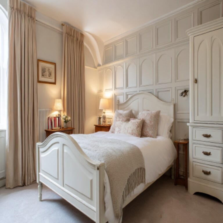 Classic Master Bedroom Design with Arched Bed, Paneled Wall and White Furniture