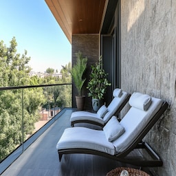 Industrial Balcony Design with Dark Metal Planters and Rattan Seating