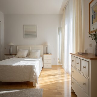Contemporary Bedroom Design With A White Double Bed And A Chest Of Drawers