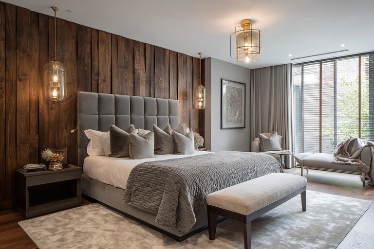 Contemporary Master Bedroom With Grey Upholstered Bed And Wooden Wall ...