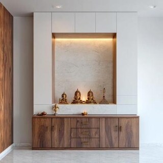 Contemporary Pooja Room Design With White Backdrop And Wooden Storage Cabinet