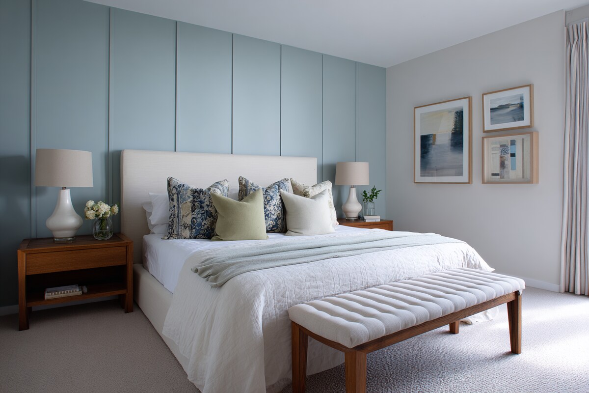 Cosy White and Blue Wall Colour Combination for Bedroom with Cushioned Bench and Bedside Lamp