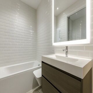 Modern Bathroom Design with White Tiles and Sleek Vanity Storage