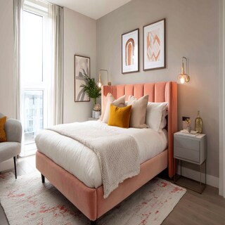 Modern Bedroom Design With A Double Size Bed Featuring A Peach Upholstered Headboard