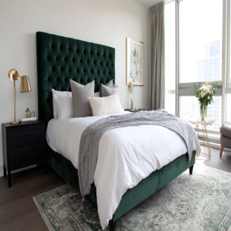 Modern Bedroom Design With A Queen Bed And A Dark Green Tufted Headboard