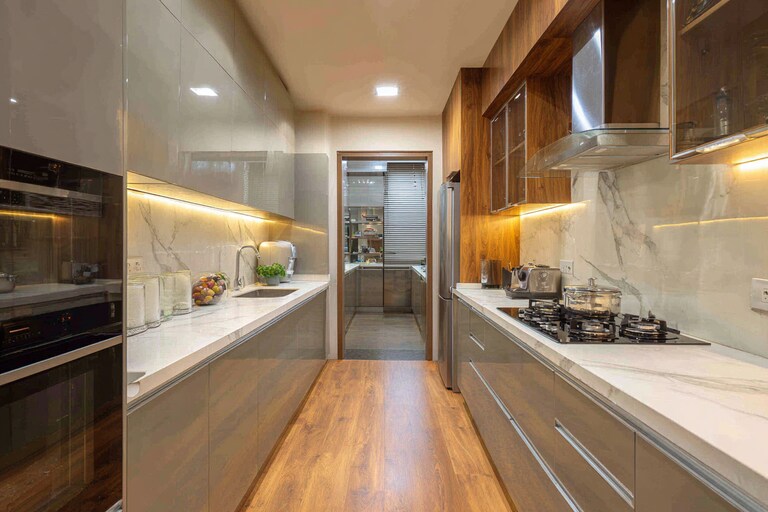 Modern Parallel Kitchen Design with Glass Cabinets and LED Accents