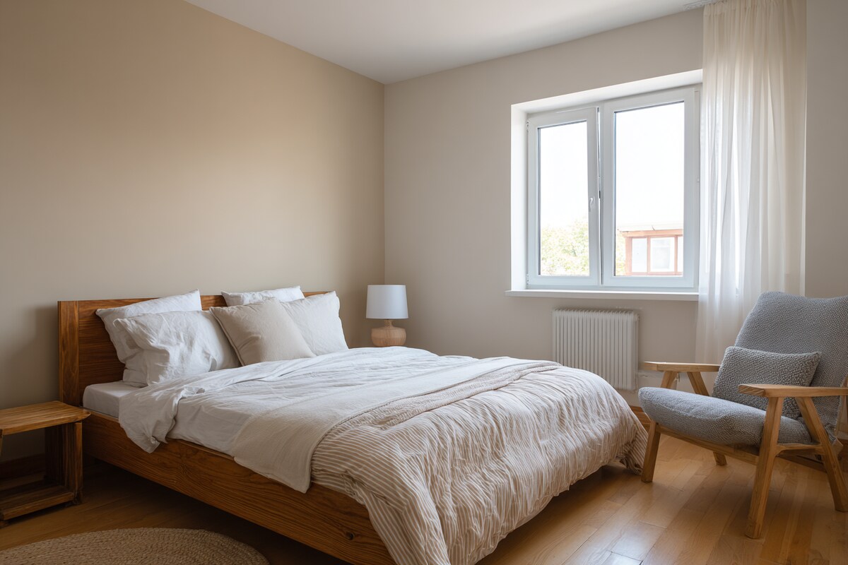 Trendy Beige and White Wall Colour Combination for Bedroom with Wooden Bed Frame and Fabric Chair
